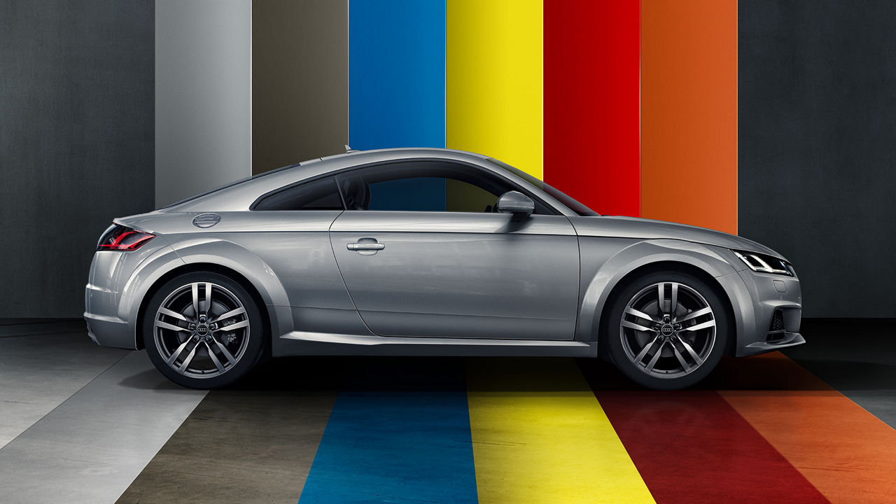 Side view of silver Audi TT Coupé with colour band floor and background.